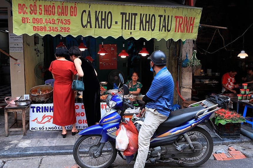 Inflation in Vietnam is low by regional standards, but core inflation rose to nearly 4.5% in October. Shoppers at a food market in Hanoi.