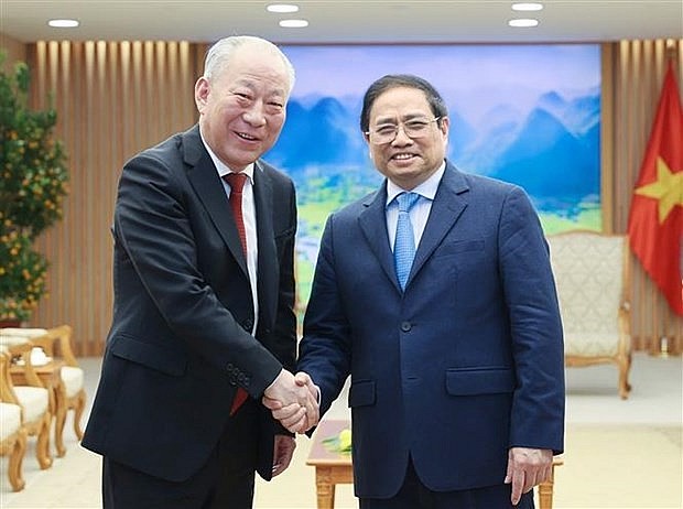 Prime Minister Pham Minh Chinh (R) and Yan Jiehe, Founder and Chairman of China Pacific Construction Group. Photo: VNA Prime Minister Pham Minh Chinh (R) and Yan Jiehe, Founder and Chairman of China Pacific Construction Group. Photo: VNA