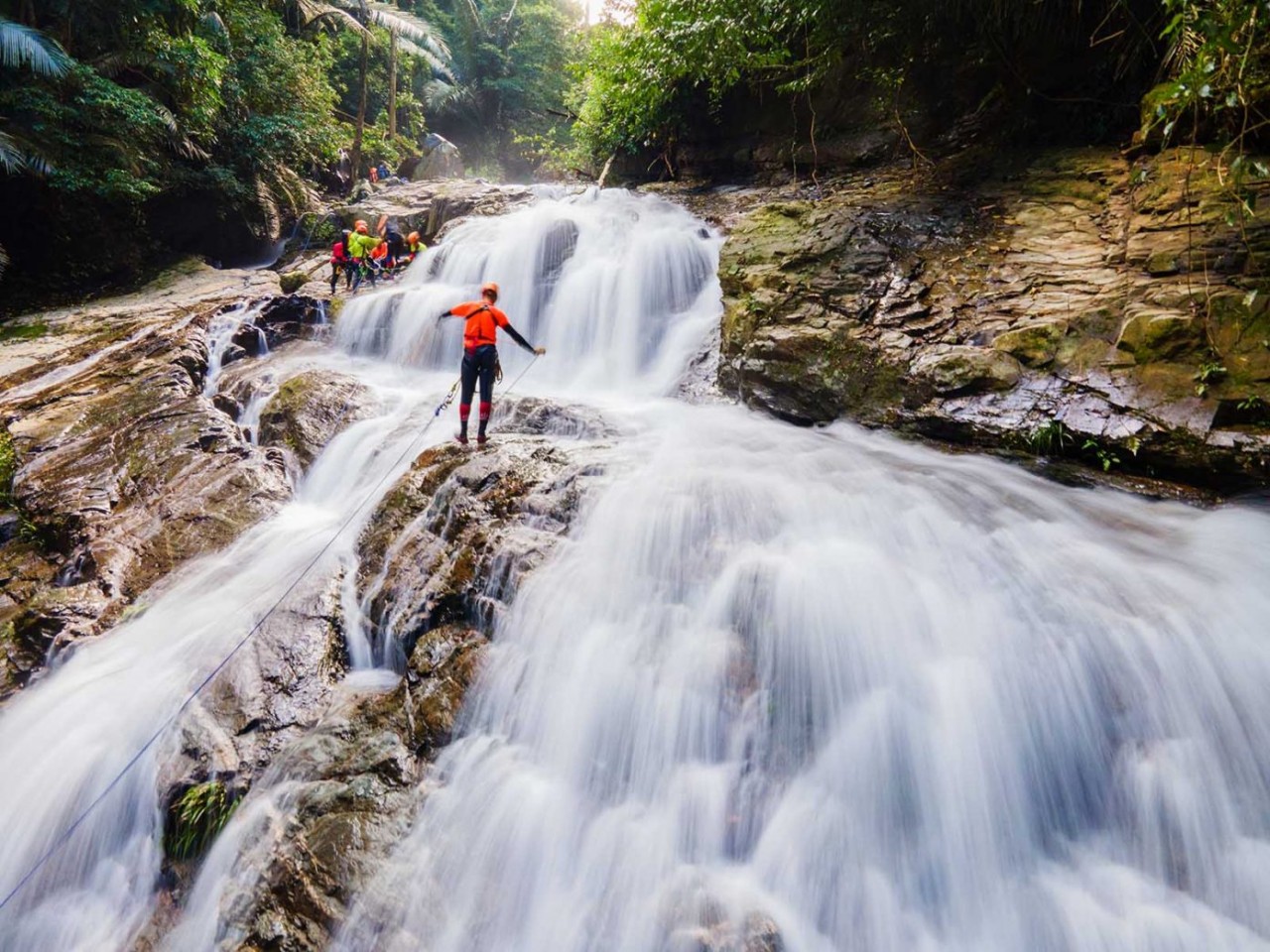 Visitors experience the adventurous rope swing over Duong Cam waterfall. Photo: Netin Visitors experience the adventurous rope swing over Duong Cam waterfall. Photo: Netin