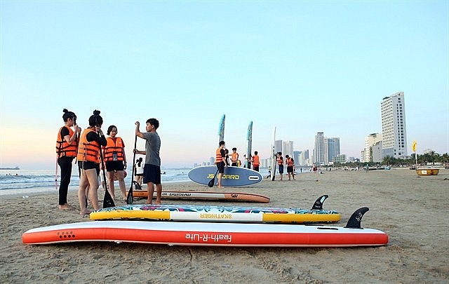 Tourists at a beach in Đà Nẵng City. Domestic tours to islands and beaches are popular during the coming Reunification Day and International Labour Day holidays.