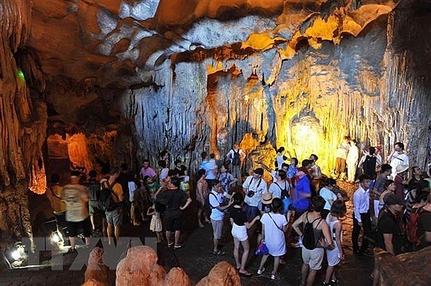 Tourists visit a cave in Ha Long Bay in the northeastern province of Quang Ninh. (Photo: VNA) Tourists visit a cave in Ha Long Bay in the northeastern province of Quang Ninh. (Photo: VNA)