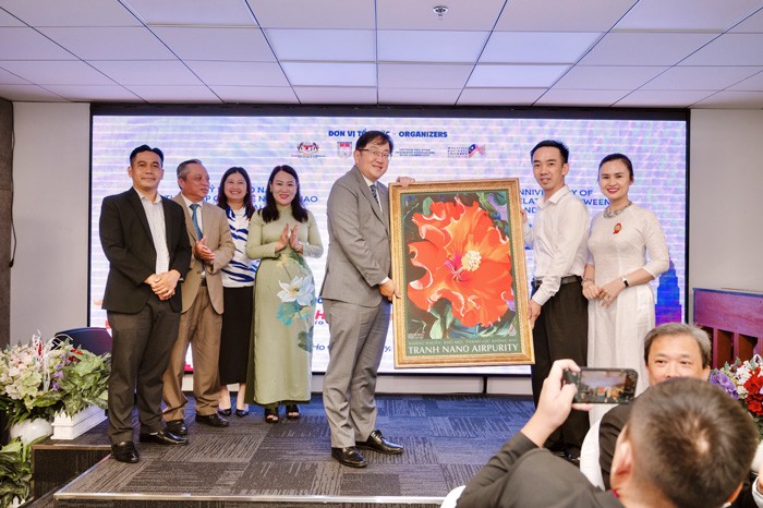 Representative of Vietnamese enterprises presents paintings to Malaysian Ambassador to Vietnam Dato Tan Yang Thai. Photo: VNA Representative of Vietnamese enterprises presents paintings to Malaysian Ambassador to Vietnam Dato Tan Yang Thai. Photo: VNA