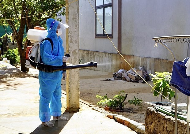 A health worker sprays chemicals to kill mosquitoes. A health worker sprays chemicals to kill mosquitoes.