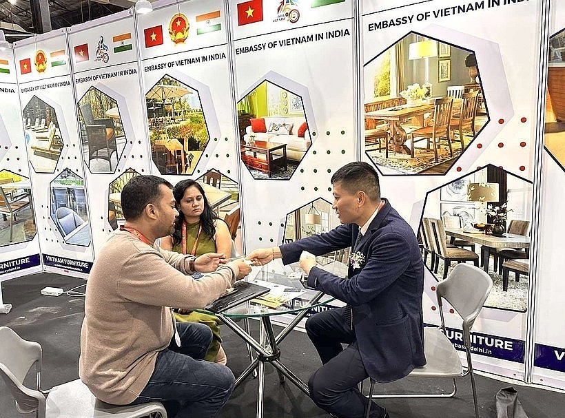 Representatives of the Vietnam Trade Office in India exchange information with visitors to India International Furniture Fair at the Vietnamese product display booth. Photo: VNA Representatives of the Vietnam Trade Office in India exchange information with visitors to India International Furniture Fair at the Vietnamese product display booth. Photo: VNA