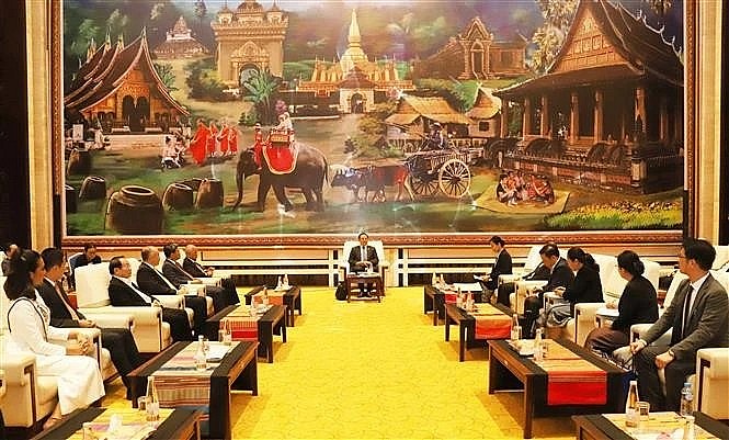 At the February 14 meeting between Lao Prime Minister Sonexay Siphandone and a delegation of Vietnamese businesses and international enterprises from various countries. (Photo: VNA) At the February 14 meeting between Lao Prime Minister Sonexay Siphandone and a delegation of Vietnamese businesses and international enterprises from various countries. (Photo: VNA)