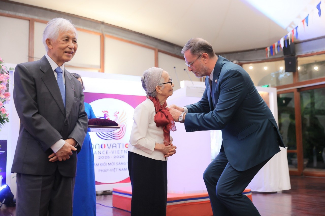 French Ambassador to Vietnam Olivier Brochet confers the Legion of Honour, Officer Class, on Professor Lê Kim Ngọc. (Photo: Government News)