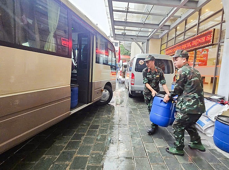 Military medical staff load Chloramin B – a water disinfectant chemical – onto a truck. Military medical staff load Chloramin B – a water disinfectant chemical – onto a truck.