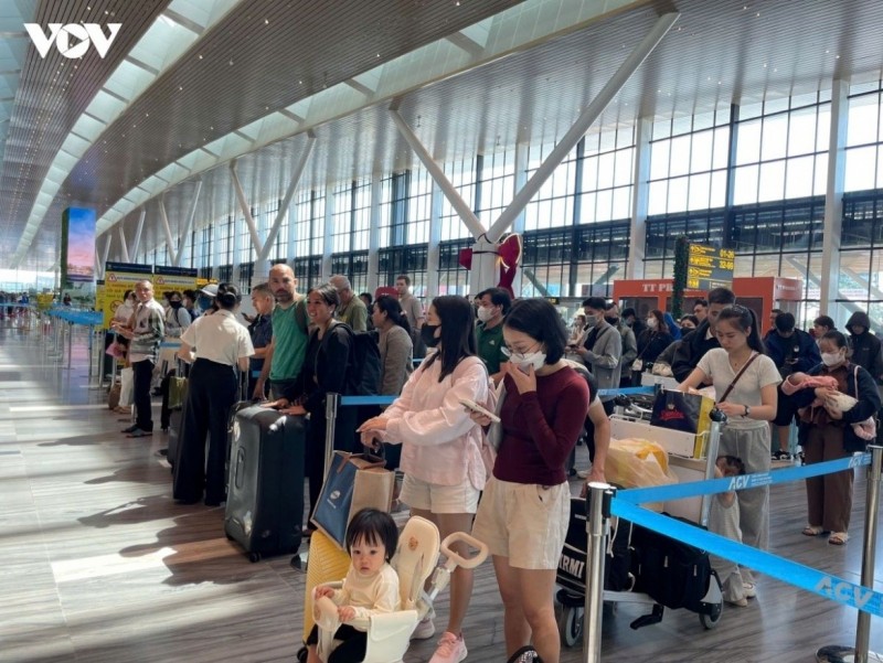 Passengers queue for check-in at Tan Son Nhat International Airport.