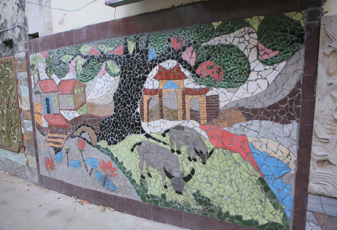 Colorful village road created by discarded bottles and scrap Colorful village road created by discarded bottles and scrap
