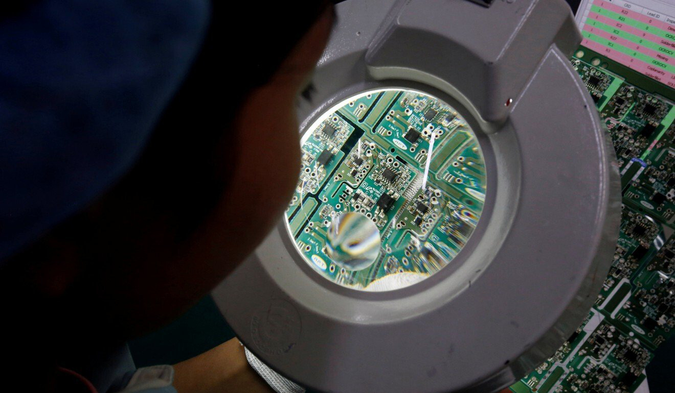 undefined A woman inspects a circuit board at Manutronics Factory in Bac Ninh province, Vietnam