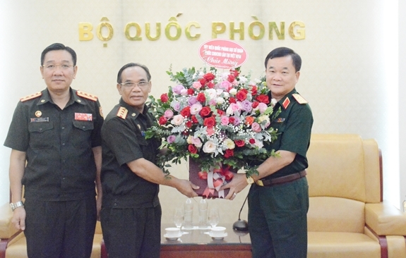 Đại tá Bangsy Xaysomkhoth và Đại tá Vongxay Inthakham tặng hoa chúc mừng Trung tướng Hoàng Xuân Chiến. 3317 3 1