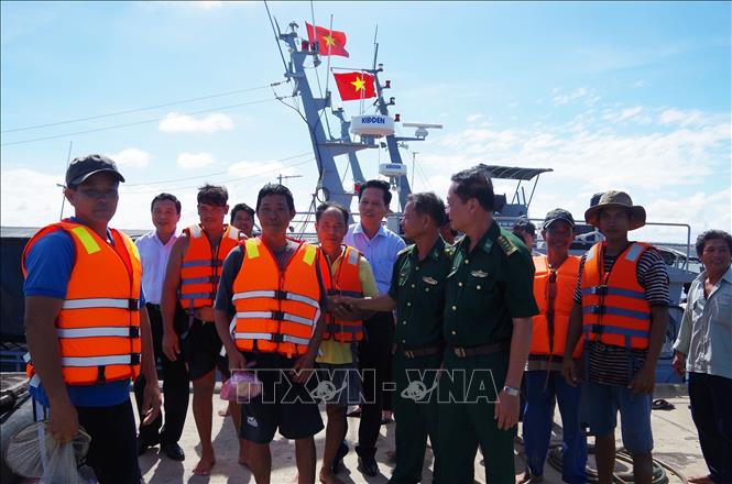 Lãnh đạo Bộ Chỉ huy Bộ đội Biên phòng Tiền Giang và huyện Gò Công Đông, tỉnh Tiền Giang đón ngư dân bị nạn ngay tại cầu cảng Hải đội 2, ngày 24/12. Ảnh: Hữu Chí/TTXVN