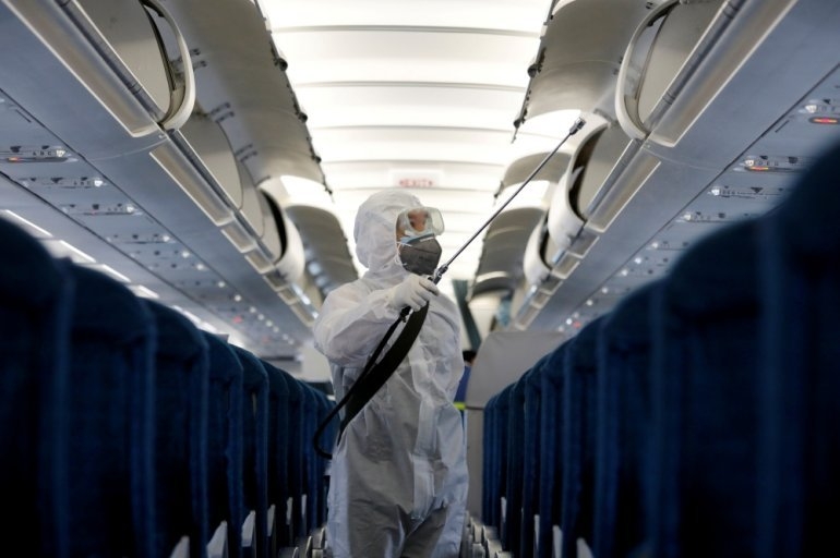 undefined A health worker sprays disinfectant inside a Vietnam Airlines airplane to protect from the recent coronavirus outbreak, at Noi Bai airport in Hanoi, Vietnam February 21, 2020. (Photo: Reuters)