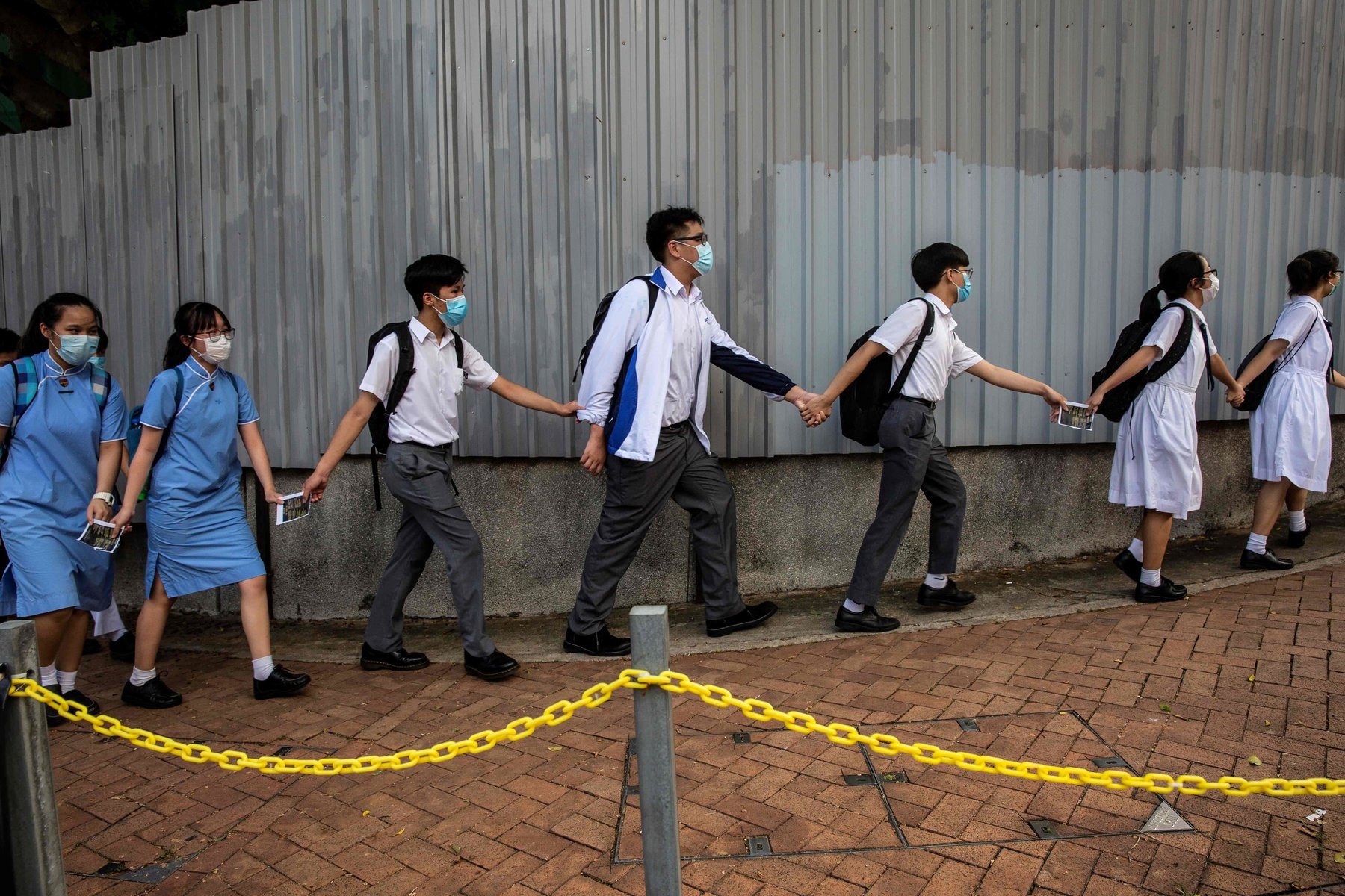 undefined Hong Kong students are banned from singing the protest anthem “Glory to Hong Kong,” posting slogans with political messages or forming human chains