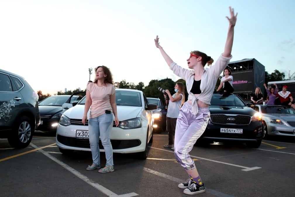 Outdoor life in COVID-19 time Fans dance by a car during a performance of the rock ban The Hatters in Moscow, Russia