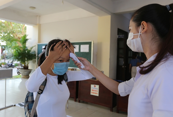 undefined One student is checked for body temperature