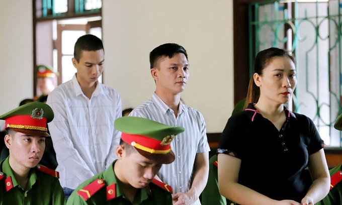undefined (From L) Nguyen Quoc Thanh, Tran Dinh Truong and Nguyen Thi Thuy Hoa stand trial in Ha Tinh, September 14, 2020.