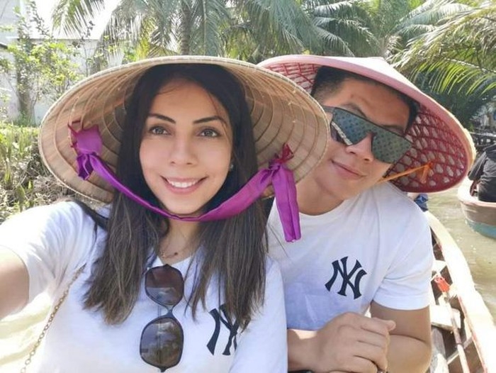 Romantic love story of a Vietnamese boy and Palestinian girl Tho and jubran first met each other at technical university of sydney. in the photo, both are wearing conical hat, traditional hat vietnam