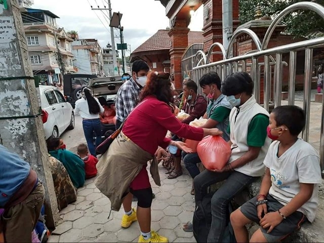 undefined Poor Napalese get donated rice from Vo Thi Kim Cuong