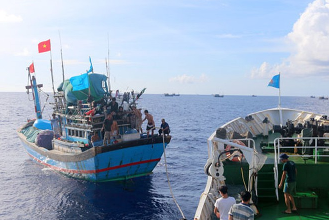 a fishing boat and three binh dinh fishermen being rescued