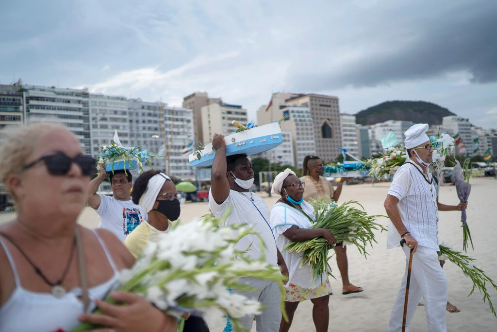 As part of New Year’s Eve celebrations in Rio, Brazilians flock to the beach to pay homage to Yemanja, the goddess of the seas (Photo: Associated Press) 2906 30xp newyearseve6a jumbo