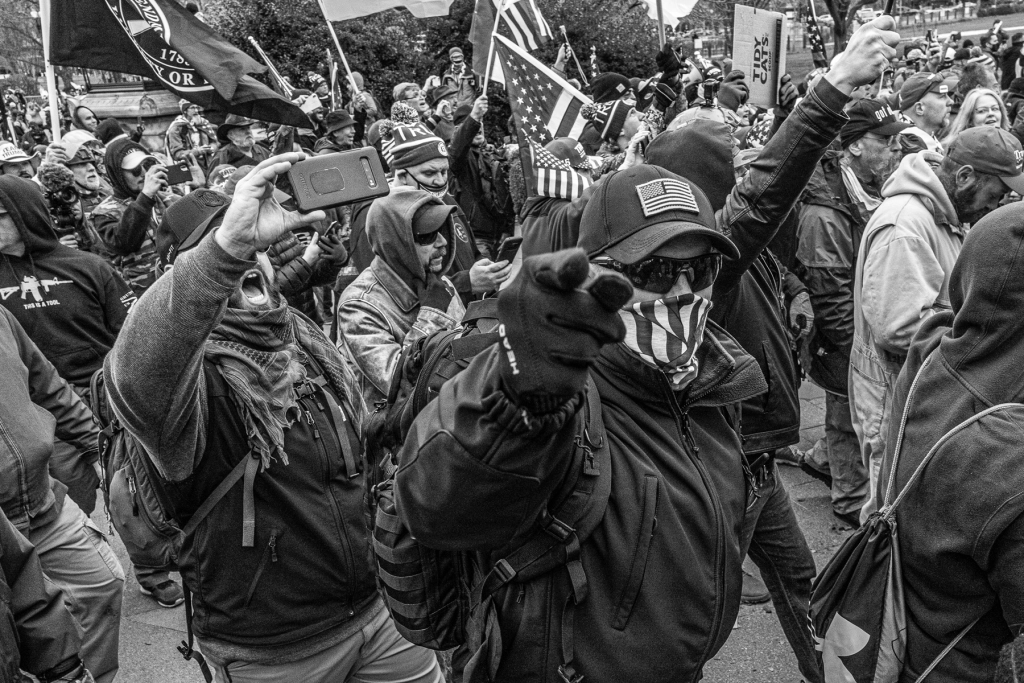 A man threatens the photographer just before shoving him off a balustrade as the first line of barriers to the U.S. Capitol were breached in Washington, D.C., on January 6th, 2021. (Photo: Nate Gowdy for Rolling Stone) 2527 010621 stop the steal credit nate gowdy 07