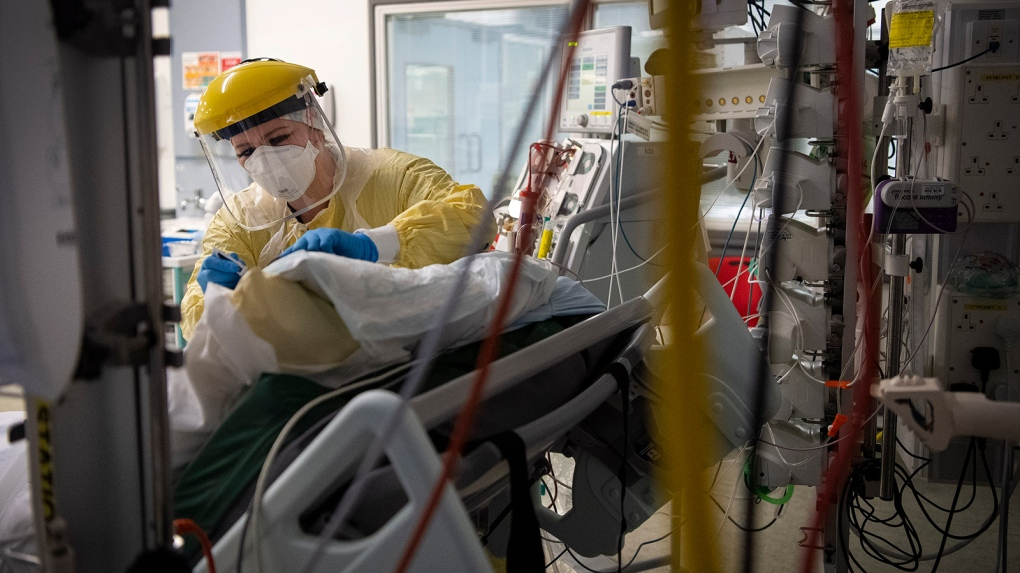 A U.K. study suggests COVID-19 infection grants immunity for five months. Seen here, a nurse works with a patient inside the Intensive Care Unit at St. George's Hospital in London, on January 6. (Photo: Victoria Jones/AP) 2601 image 1