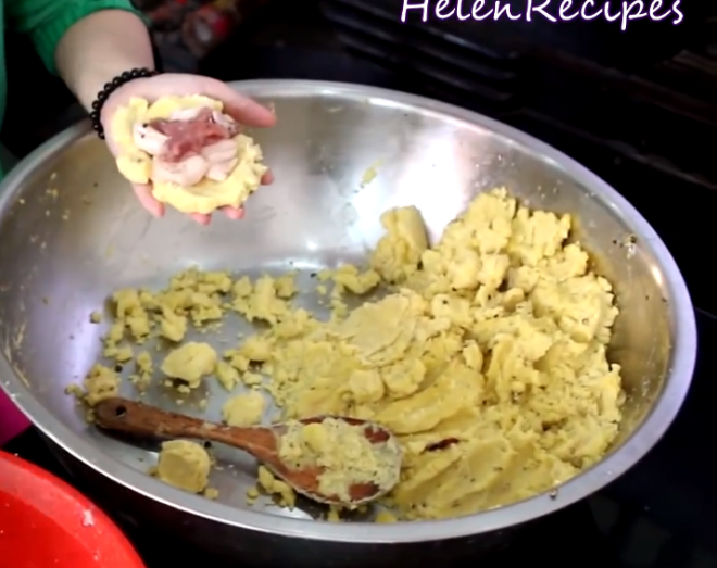 4. Take about a cup of the mashed mung beans, spread out on a saran wrap, add a few pieces of pork lean and fat and wrap it up shaping into a round or square piece. 2701 41