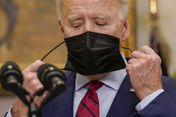 President Joe Biden removes his mask before speaking on the economy in the Roosevelt Room of the White House, Saturday, Feb. 27, 2021, in Washington. (AP Photo/Pablo Martinez Monsivais) 0039-8
