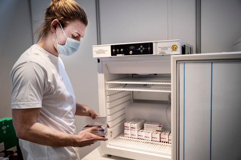 Staff member handles AstraZeneca COVID-19 vaccines in storage at Region Hovedstaden's Vaccine Center, Copenhagen, Denmark February 11, 2021. Ritzau Scanpix/Liselotte Sabroe via REUTERS THIS IMAGE HAS BEEN SUPPLIED BY A THIRD PARTY./File Photo 2900-mediazenfs