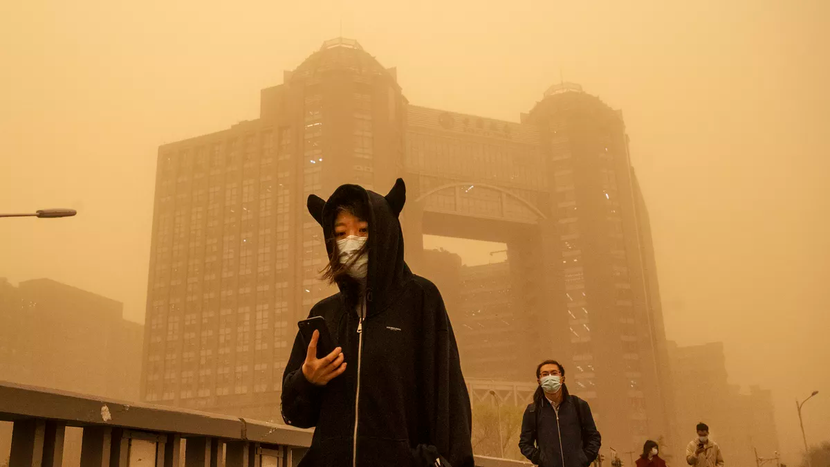 People wear protective masks as they commute during a sandstorm on March 15 in Beijing, China. Kevin Frayer/Getty Images 5909-cdnvox-cdn
