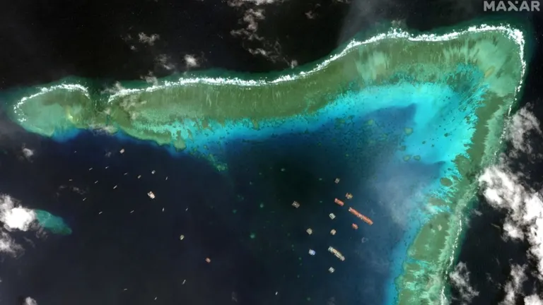 Satellite view of fishing vessels in the Whitsun Reef, which Manila calls the Julian Felipe Reef, in this Maxar image taken March 23. © Reuters Satellite view of fishing vessels in the Whitsun Reef, which Manila calls the Julian Felipe Reef, in this Maxar image taken March 23. © Reuters