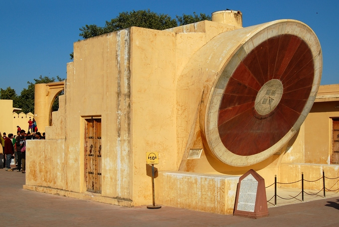 The Samrat Yantra in Jaipur is part of the Jantar Mantar (translation: instruments for calculation), a Big Collection of 14 devices built for measuring time, for astronomy, and for astrology, in the 18th century. Historical accounts say that, in 1719, Mogul emperor Mohammad Shah was leaving on an expedition. But the planets, weren't in the “right” spots in the night sky. This misalignment due to failed predictions spurred Maharajah Sawai Jai Singh II to build a series of observatories. When Singh decided to move and found a new city (what would be Jaipur) in a nearby valley, he also had a new observatory built there. The Samrat Yantra in Jaipur is part of the Jantar Mantar (translation: instruments for calculation), a Big Collection of 14 devices built for measuring time, for astronomy, and for astrology, in the 18th century. Historical accounts say that, in 1719, Mogul emperor Mohammad Shah was leaving on an expedition. But the planets, weren't in the “right” spots in the night sky. This misalignment due to failed predictions spurred Maharajah Sawai Jai Singh II to build a series of observatories. When Singh decided to move and found a new city (what would be Jaipur) in a nearby valley, he also had a new observatory built there.