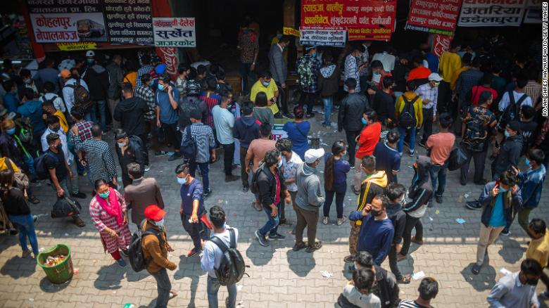 People wait to board a bus back to their home villages after new government restrictions in Kathmandu, Nepal, on April 27. (Photo: CNN) People wait to board a bus back to their home villages after new government restrictions in Kathmandu, Nepal, on April 27. (Photo: CNN)