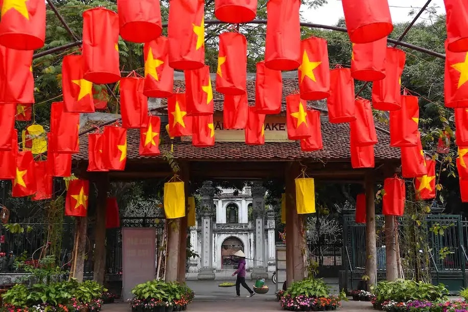A food vendor walks past the Temple of Literature in Hanoi on Feb. 3. (Nhac Nguyen/AFP/Getty Images) A food vendor walks past the Temple of Literature in Hanoi on Feb. 3. (Nhac Nguyen/AFP/Getty Images)