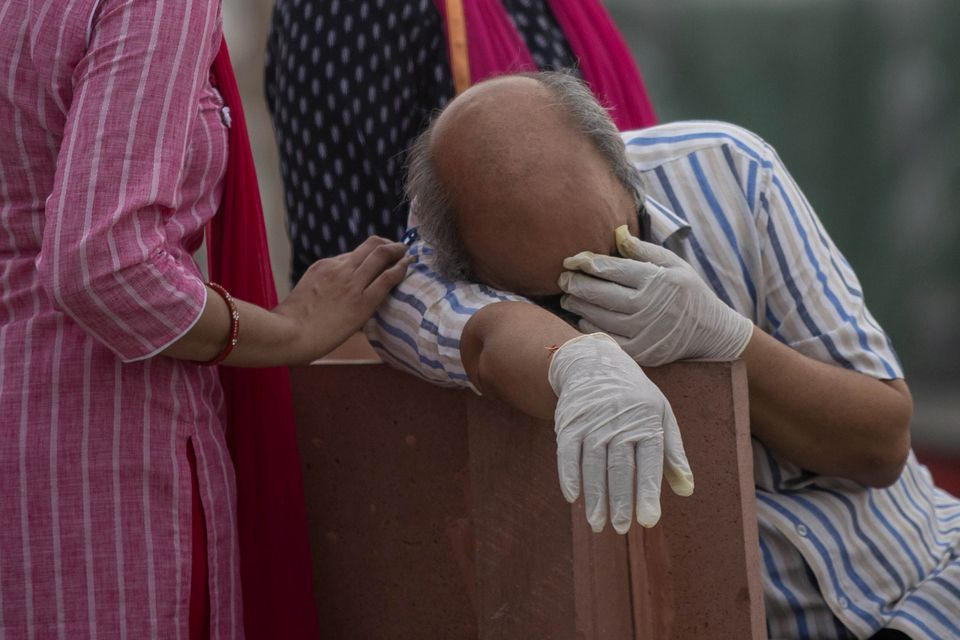 A man reacts before the cremation of his relative, who died from the coronavirus disease (COVID-19), on the banks of the river Ganges at Garhmukteshwar in the northern state of Uttar Pradesh, India, May 6, 2021. REUTERS/Danish Siddiqui A man reacts before the cremation of his relative, who died from the coronavirus disease (COVID-19), on the banks of the river Ganges at Garhmukteshwar in the northern state of Uttar Pradesh, India, May 6, 2021. REUTERS/Danish Siddiqui