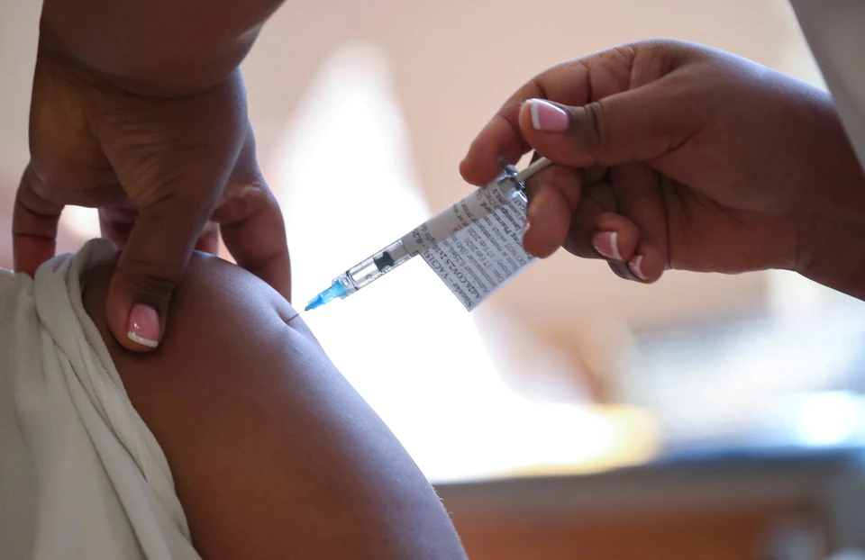 A healthcare worker receives the Johnson and Johnson coronavirus disease (COVID-19) vaccination at Khayelitsha Hospital near Cape Town, South Africa, February 17, 2021. REUTERS/Mike Hutchings A healthcare worker receives the Johnson and Johnson coronavirus disease (COVID-19) vaccination at Khayelitsha Hospital near Cape Town, South Africa, February 17, 2021. REUTERS/Mike Hutchings