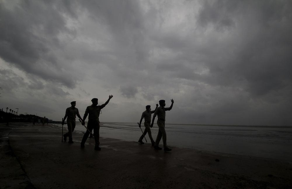 Policemen ask people to move to cyclone shelters as they patrol a beach in Balasore district in Odisha, India, Tuesday, May 25, 2021. Tens of thousands of people were evacuated Tuesday in low-lying areas of two Indian states and moved to cyclone shelters to escape a powerful storm barreling toward the eastern coast. (AP Photo) Policemen ask people to move to cyclone shelters as they patrol a beach in Balasore district in Odisha, India, Tuesday, May 25, 2021. Tens of thousands of people were evacuated Tuesday in low-lying areas of two Indian states and moved to cyclone shelters to escape a powerful storm barreling toward the eastern coast. (AP Photo)