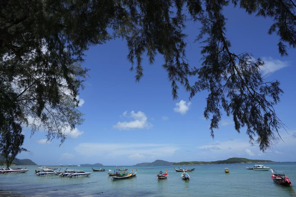 Empty tourist boats anchor off Rawai Beach on Phuket, southern Thailand, Monday, June 28, 2021. Thailand's government will begin the