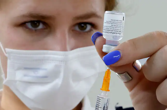An Israeli medical worker prepares a dose of the Pfizer-BioNTech coronavirus vaccine in Tel Aviv on July 5. (Jack Guez/AFP/Getty Images) An Israeli medical worker prepares a dose of the Pfizer-BioNTech coronavirus vaccine in Tel Aviv on July 5. (Jack Guez/AFP/Getty Images)