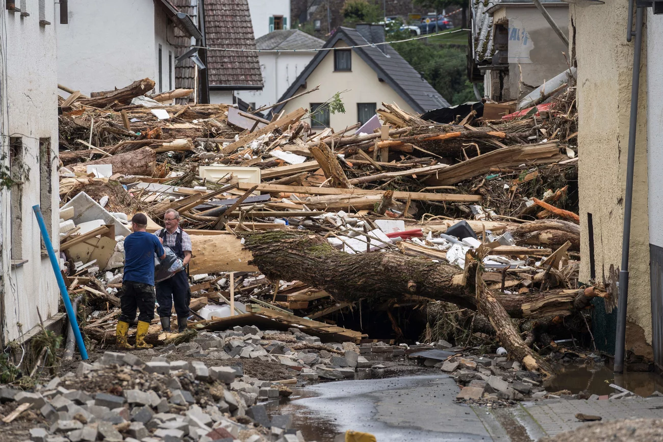 Two men try to secure goods near houses destroyed by floods Thursday in Schuld. Bernd Lauter/AFP via Getty Images Two men try to secure goods near houses destroyed by floods Thursday in Schuld. Bernd Lauter/AFP via Getty Images