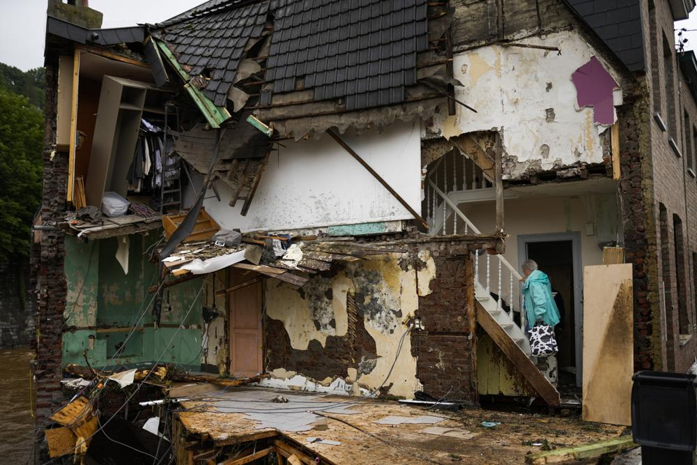 A woman walks up the stairs in her damaged house after flooding in Ensival, Vervier, Belgium, Friday July 16, 2021. Photo: AP A woman walks up the stairs in her damaged house after flooding in Ensival, Vervier, Belgium, Friday July 16, 2021. Photo: AP