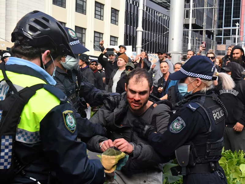 Police arrest a protester at a demonstration at Sydney Town Hall during an anti-lockdown rally on Saturday. Mick Tsikas/AP Police arrest a protester at a demonstration at Sydney Town Hall during an anti-lockdown rally on Saturday. Mick Tsikas/AP