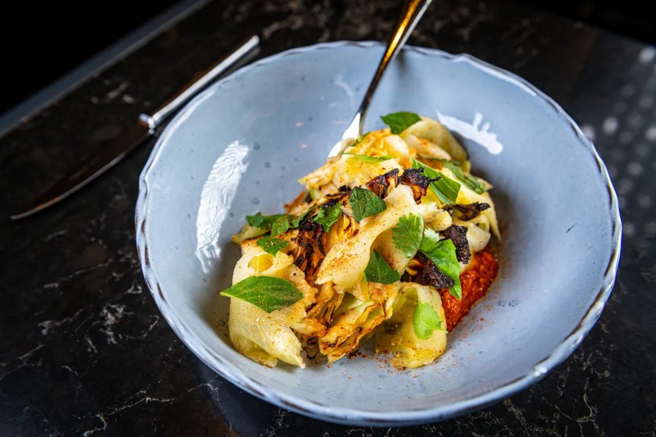 Charred Carafalex cabbage at Moon Rabbit comes with slices of pineapple and a spicy peanut romesco sauce meant to evoke bún bò huế Rey Lopez/Eater D.C. Charred Carafalex cabbage at Moon Rabbit comes with slices of pineapple and a spicy peanut romesco sauce meant to evoke bún bò huế Rey Lopez/Eater D.C.