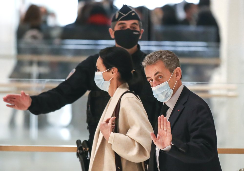 In this Dec.10, 2020 file photo, former French President Nicolas Sarkozy waves to the media as he arrives at the courtroom in Paris. The verdict is expected on Monday in a landmark trial for corruption and influence-peddling that has put French former President Nicolas Sarkozy in the spotlight, leading prosecutors to request two years in prison for him. Sarkozy, who was president from 2007 to 2012, has firmly denied any wrongdoing during the 10-day trial. (AP Photo/Michel Euler, File) 3632-president