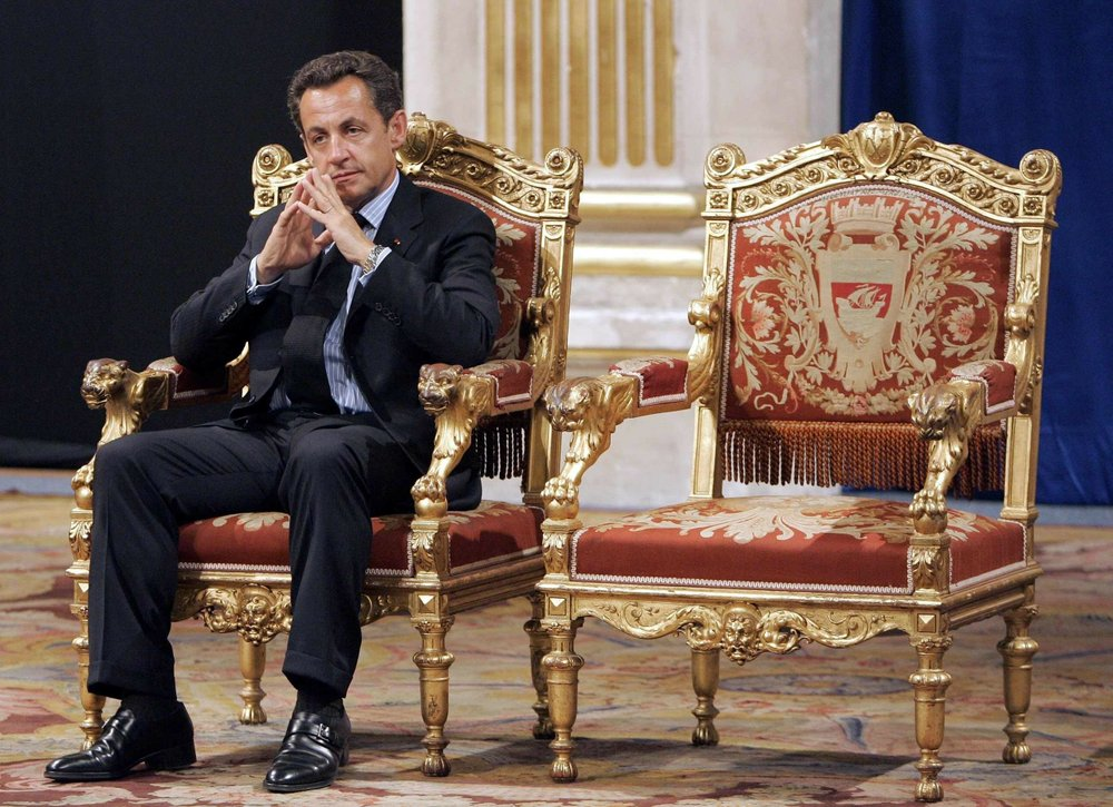 In this Thursday, May, 24, 2007 file photo, French President Nicolas Sarkozy sits during an official and traditional ceremony with Paris mayor Bertrand Delanoe, whose empty chair is at right, during which the newly elected President is met by the Paris mayor at the Paris city hall, France. A Paris court on Monday found French former President Nicolas Sarkozy guilty of corruption and influence peddling and sentenced him to one year in prison and a two-year suspended sentence. The 66-year-old politician, who was president from 2007 to 2012, was convicted for having tried to illegally obtain information from a senior magistrate in 2014 about a legal action in which he was involved. (AP Photo/C 3740-french-president-2