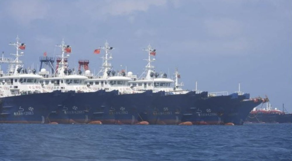 In this March 7, 2021, photo provided by the Philippine Coast Guard/National Task Force-West Philippine Sea, some of the 220 Chinese vessels are seen moored at Whitsun Reef, South China Sea. The Philippine government expressed concern after spotting more than 200 Chinese fishing vessels it believed were crewed by militias at a reef claimed by both countries in the South China Sea, but it did not immediately lodge a protest. (Philippine Coast Guard/National Task Force-West Philippine Sea via AP) In this March 7, 2021, photo provided by the Philippine Coast Guard/National Task Force-West Philippine Sea, some of the 220 Chinese vessels are seen moored at Whitsun Reef, South China Sea. The Philippine government expressed concern after spotting more than 200 Chinese fishing vessels it believed were crewed by militias at a reef claimed by both countries in the South China Sea, but it did not immediately lodge a protest. (Philippine Coast Guard/National Task Force-West Philippine Sea via AP)