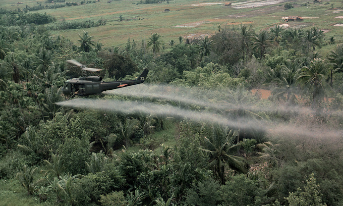 A U.S. helicopter sprays Agent Orange on a dense jungle area in the Mekong Delta during the Vietnam War. Photo by Shutterstock. A U.S. helicopter sprays Agent Orange on a dense jungle area in the Mekong Delta during the Vietnam War. Photo by Shutterstock.