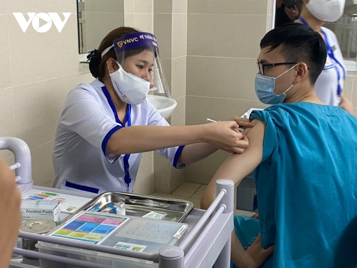 A medical worker receives a shot of AstraZeneca vaccine A medical worker receives a shot of AstraZeneca vaccine