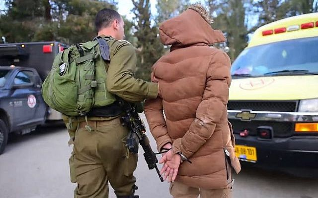 Illustrative: An Israeli soldier arresting a suspect after a raid in the West Bank city of Nablus, on March 18, 2018. (Israel Defense Forces) Illustrative: An Israeli soldier arresting a suspect after a raid in the West Bank city of Nablus, on March 18, 2018. (Israel Defense Forces)